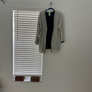 Cream colored jacket with black lining